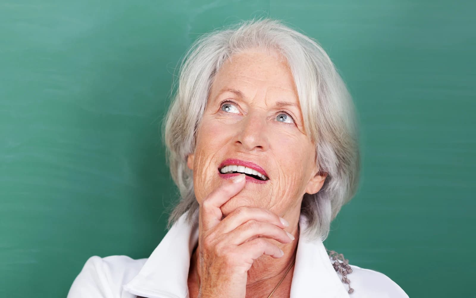 Senior woman standing thinking