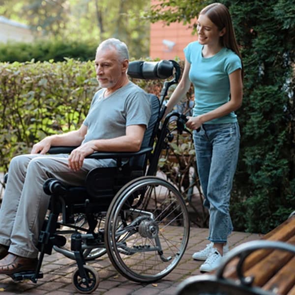 An elderly man is sitting in a wheelchair