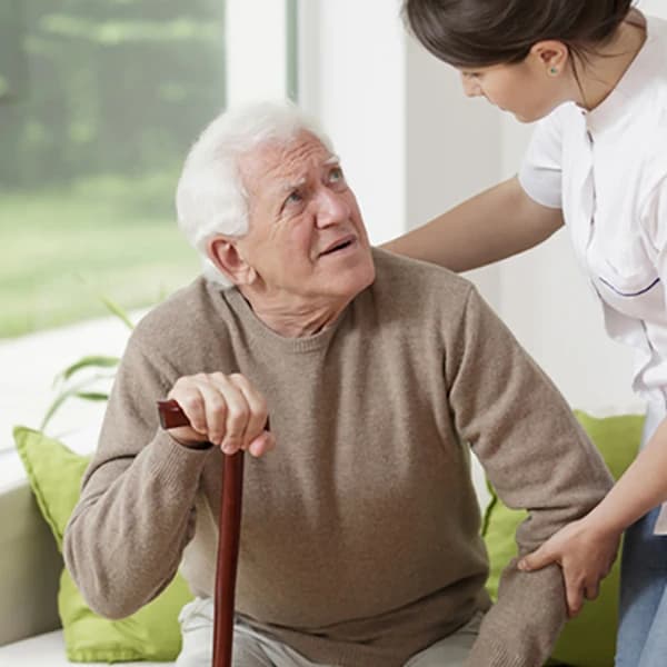 Man leaning on walking stick