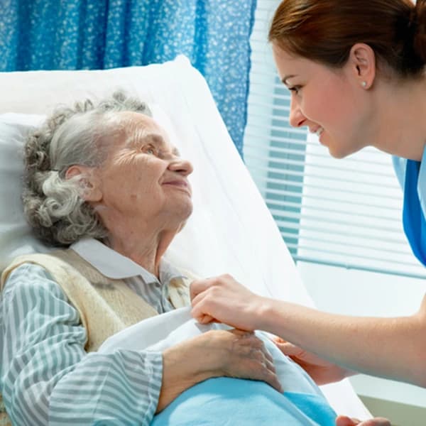 Elderly woman being cared for by nurse