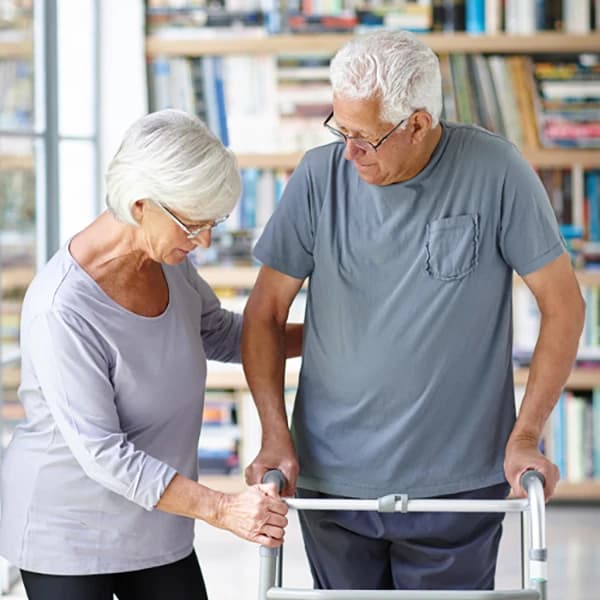 Senior woman assisting her husband