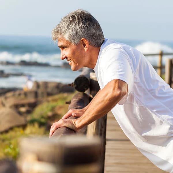 Fit senior man exercising at the beach