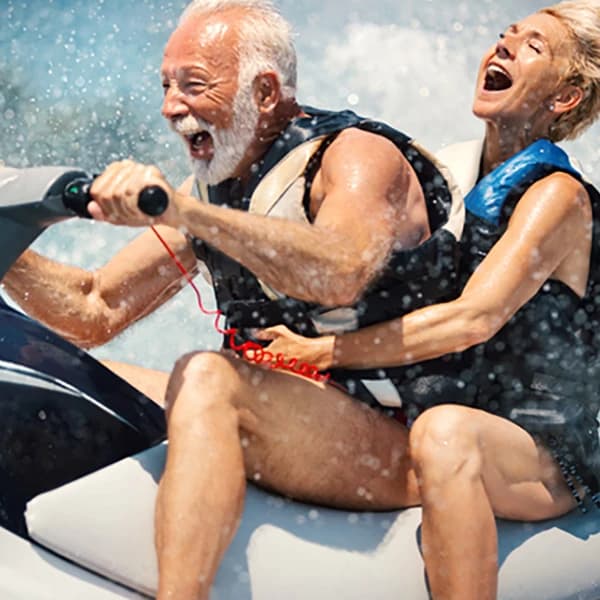Senior couple jet skiing