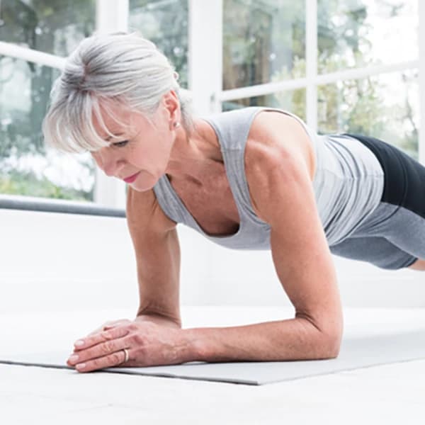 Senior woman in plank position