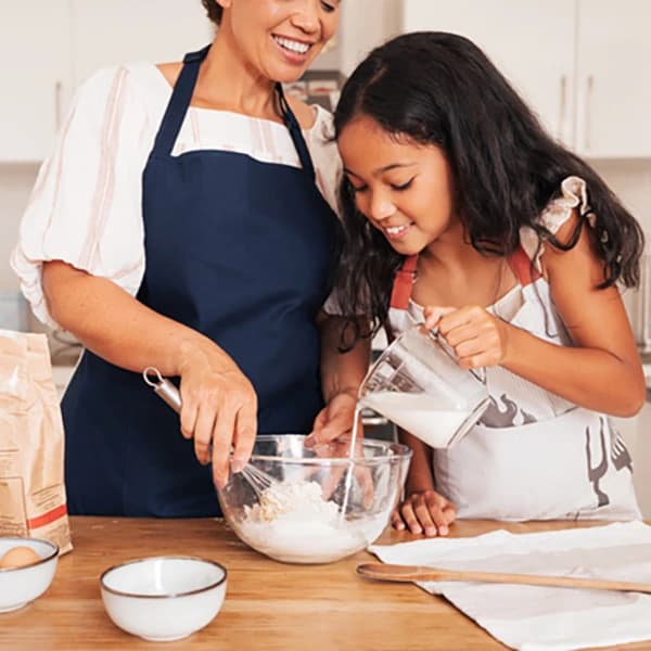 Granny and granddaughter cook together
