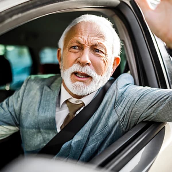 Senior man driving car